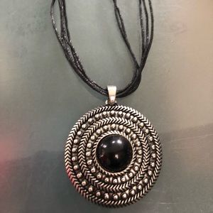 Costume necklace with large charm.